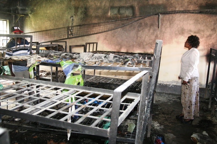 Parents and leaders examine damages after fire burnt a dormitory in Naivasha High School in 2013.