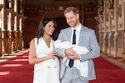 Prince Harry, Duke of Sussex and Meghan, Duchess of Sussex, pose with their newborn son during a photocall in St George's Hall at Windsor Castle on May 8 2019 in Windsor, England. 