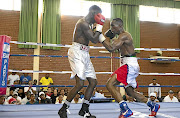 Tshifhiwa Munyai, right, on the offensive against Siphosethu Mvula  at the tournament on Sunday. / Nick Lourens