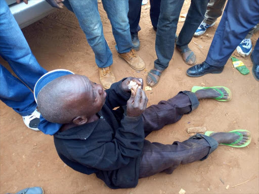 The elderly man pleads with locals at Migwani who wanted him lynched on witchcraft claims. /LYDIA NGOOLO