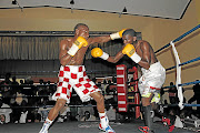 Lwandile Sityatha, left, and Siphosethu Mvula exchange the leather. Mvula has since rejoined his previous trainer  after realising that his boxing career was headed for the scrapheap.  