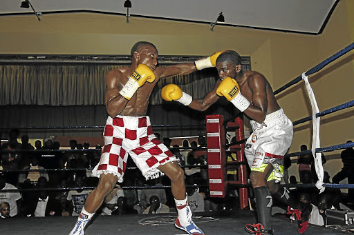 Lwandile Sityatha, left, and Siphosethu Mvula exchange the leather. Mvula has since rejoined his previous trainer after realising that his boxing career was headed for the scrapheap.