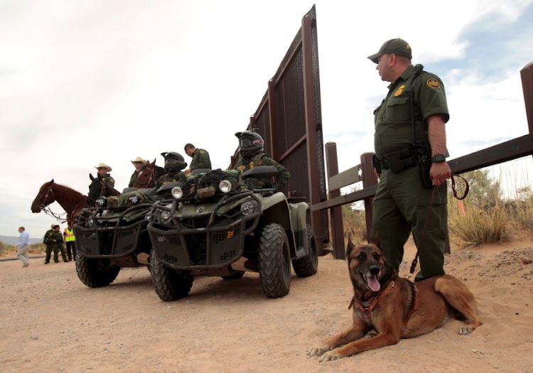 Border Patrol agents keep watch during the official start for the construction of new bollard wall to replace 20-miles of primary vehicle barriers in Santa Teresa, New Mexico, United States April 9, 2018.