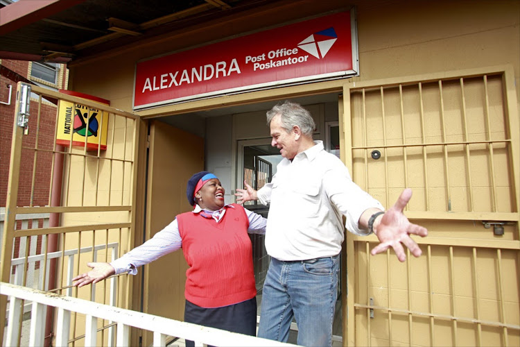 Post Office CEO Mark Barnes with staffer Gloria Malatji during a visit to branches in Alexandra.