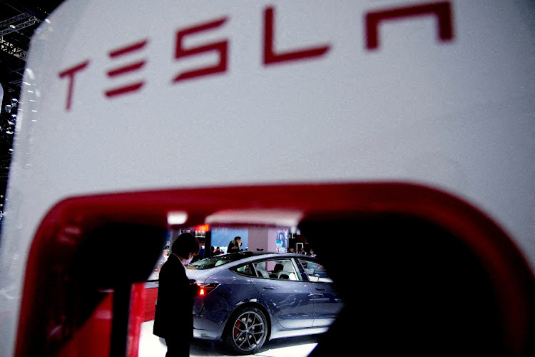 A Tesla EV is seen through a charging point displayed during a media day for the Auto Shanghai show in Shanghai, China, on April 20 2021. Picture: REUTERS/ALY SONG