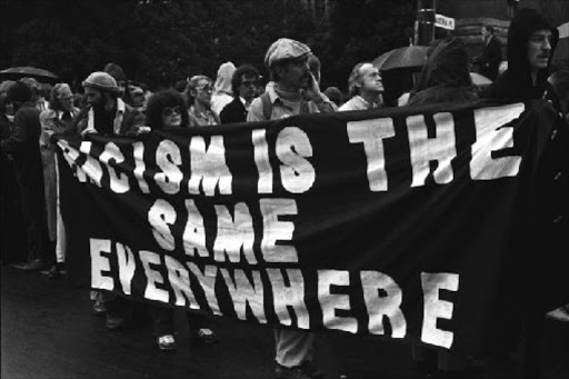 LOUD AND CLEAR: Protesters carry a banner against racism in Auckland Picture: GIL HANLY