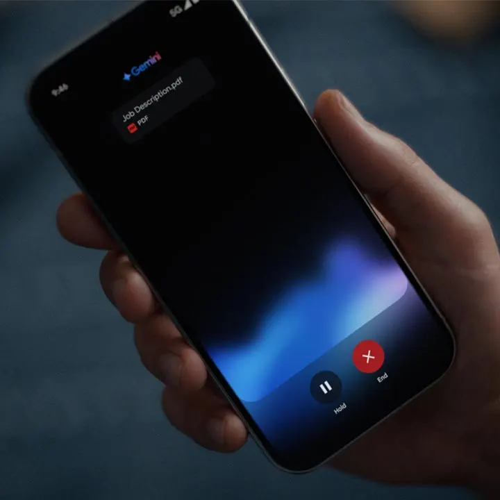 A person holding a Pixel 9 Pro with the screen showing Gemini Live and a pdf titled, Job Description. 