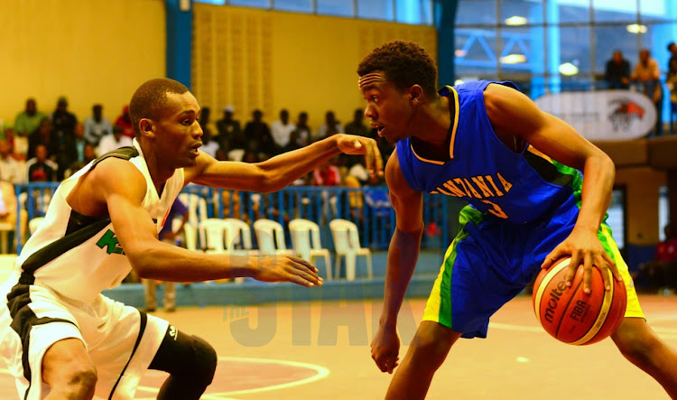 Kenya's Victor Bosire (L) challenges Ally Mohammed of Tanzania during the Fiba AfroBasket preQualifiers at Nyayo Gymnasium on January 15,2020.