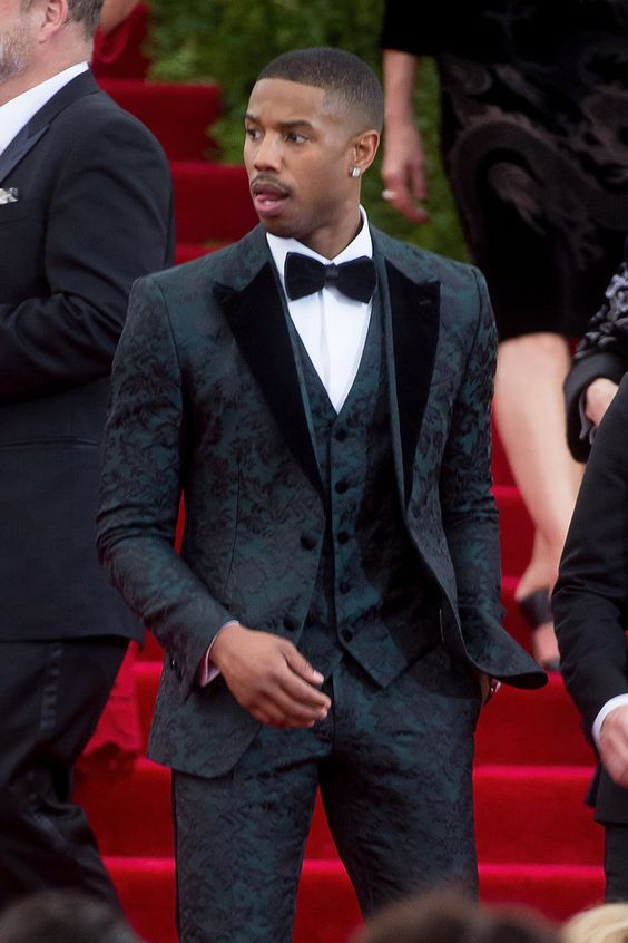 Michael B Jordan rocking a dark green rosy suit