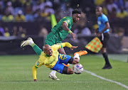 Kennedy Musonda of Young Africans tackles Khuliso Mudau of Mamelodi Sundowns during the Champions League quaterfinal second leg at Loftus. 