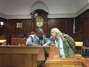 Organised Crime's Rajan Govender talks to Nan Lee after the case against her daughter's alleged killer, Philani Ntuli, was struck off the roll. 