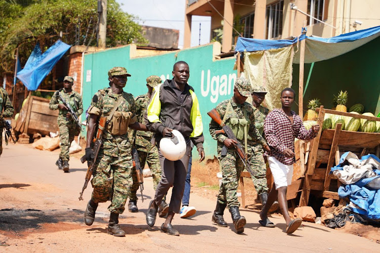 Supporter are seen being whisked away by police officers.