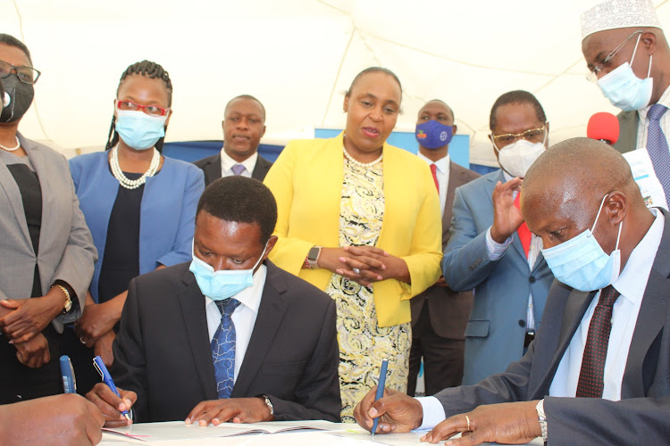 Mutua and Fisheries PS Micheni Ntiba sign the Sh15 billion ABDP deal funded by IFAD and the national government
