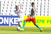 Kagiso Malinga of Swallows FC runs at Pogiso Sanoka of TS Galaxy in the DStv Premiership match at Dobsonville Stadium on January 15 2023. 