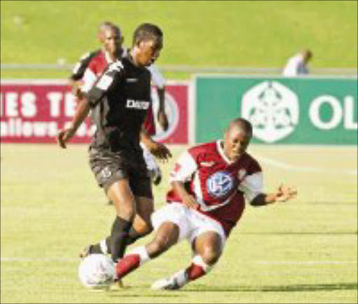 TACKLE: Platinum Stars' Lefa Mogaila, left, in a tussle for the ball with Moroka Swallows' Sibusiso Themba in their Premiership match at Germiston Stadium in Johannesburg yesterday. Pic. Chris Ricco. 09/12/07. © Backpagepix.