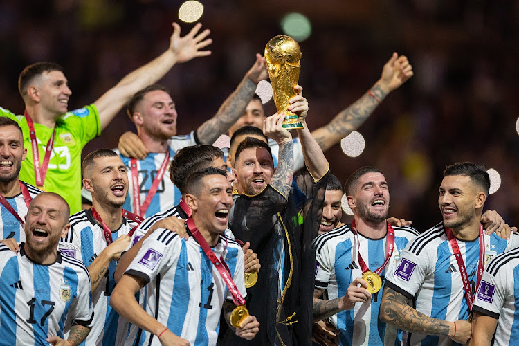 Lionel Messi of Argentina lifts the World Cup trophy alongside his teammates during the presentation after they won the World Cup final against Argentina at Lusail Stadium in Lusail City, Qatar on December 18 2022.