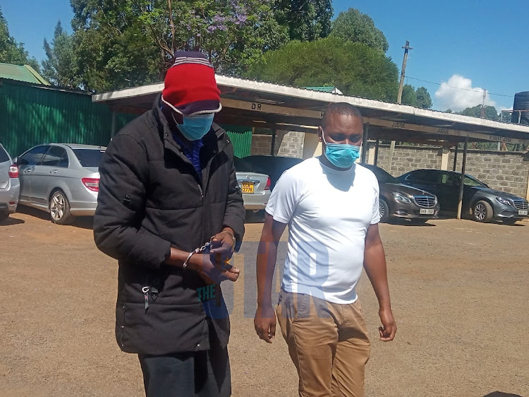 Ibrahim Rotich (in red cap) arrives at High Court in Eldoret on November 9, 2021.