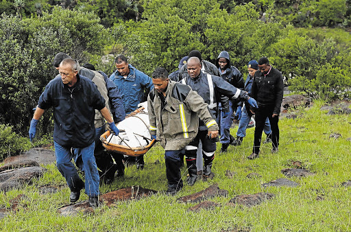 GRIM FIND: Members of a Pietermaritzburg search and rescue squad carry a body recovered from the Nzinga River believed to be that of a Nottingham Road man