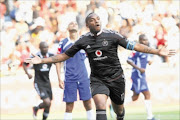 TO THE RESCUE: Orlando Pirates striker Benni McCarthy celebrates after scoring the only  goal of the match  against Maritzburg United at Orlando Stadium yesterday.  PHOTO: TLADI KHUELE/BOCHABELA PICTURES