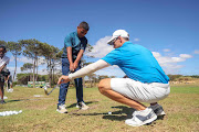 Sunshine Tour professional Michael Hollick helping SAGDB golfer Codi Ruiters with a few swing tips at the golf development clinic before this week’s Bain’s Whisky Cape Town Open at Royal Cape Golf Club.