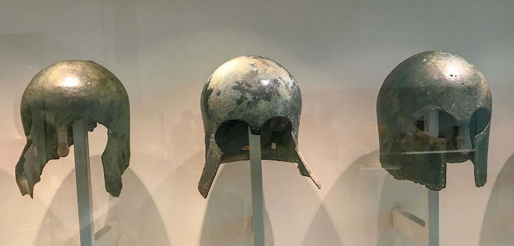   Greek bronze helmets from 600-700 B.C. After successful battle, helmets were sometimes bent and offered in a ceremony as an expression of gratitude to the gods. See it at the Altes Museum in Berlin.