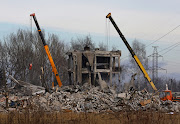 Workers remove debris of a destroyed building purported to be a vocational college used as temporary accommodation for Russian soldiers, dozens of whom were killed in a Ukrainian missile strike in Makiivka in Russia-controlled Ukraine. 