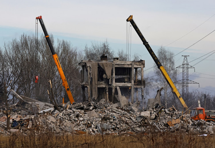 Workers remove debris of a destroyed building purported to be a vocational college used as temporary accommodation for Russian soldiers, dozens of whom were killed in a Ukrainian missile strike in Makiivka in Russia-controlled Ukraine.