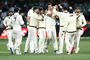 Pat Cummins of Australia celebrates with his team after taking the wicket of Prithvi Shaw of India during day two of the First Test match between Australia and India at Adelaide Oval on December 18, 2020 in Adelaide, Australia. 