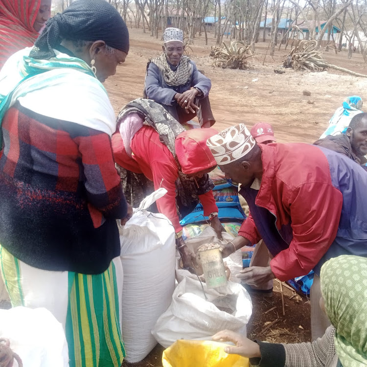 Residents receive relief food distributed by Marsabit county government.