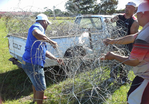 NO MORE: Members of the United Rugby Club yesterday disconnected and confiscated hundreds of metres of illegal electricity wires connected IG Foster Grounds in Vergenoeg Picture: SUPPLIED