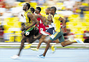 Usain Bolt surges ahead of Anaso Jobodwana of South Africa, right, in the 200m semifinal during the IAAF World Athletics Championships in Moscow last month. Henrico Bruintjies will be hoping to play a key role in the relay. File photo.