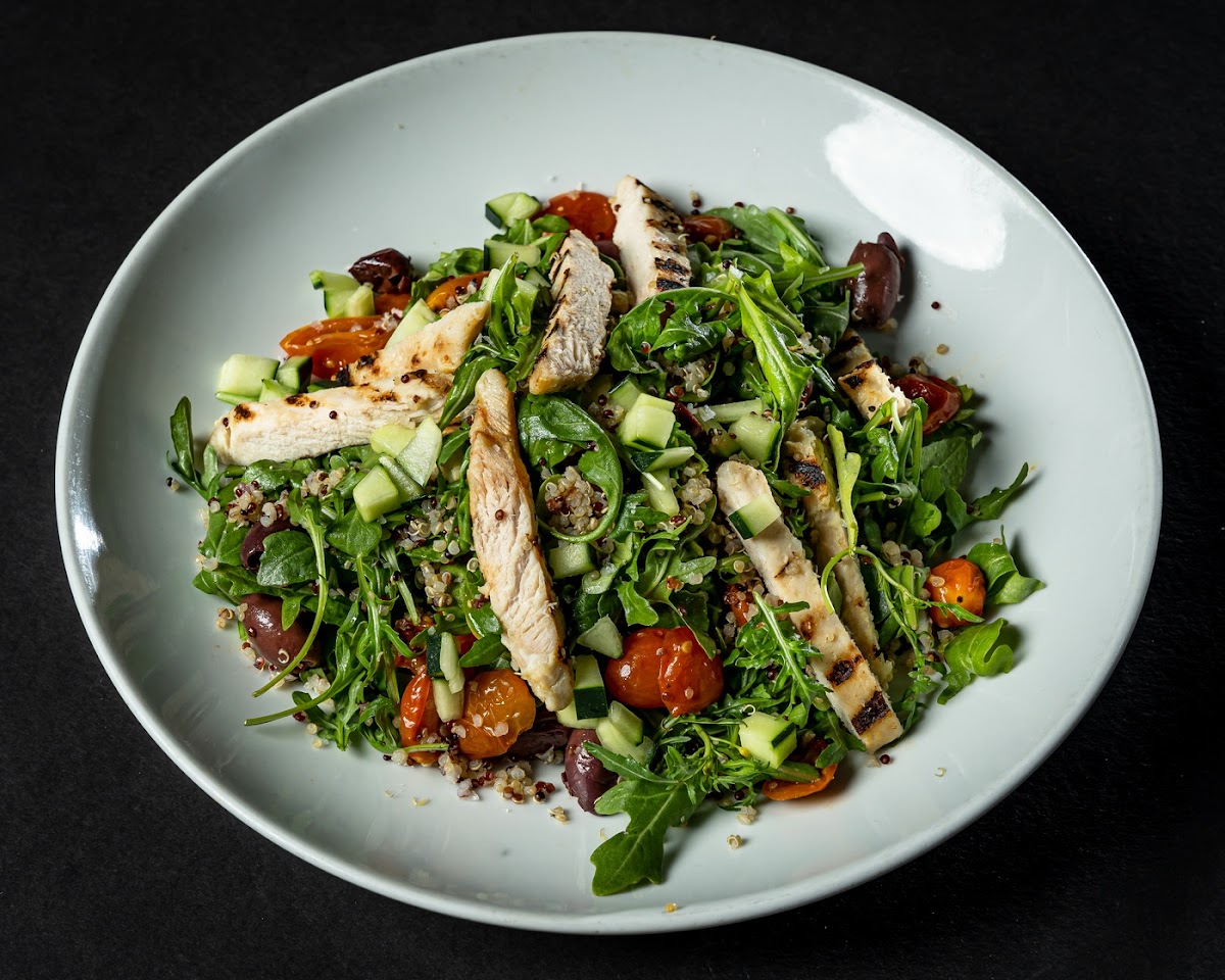 Machu Picchu salad with sauteed chicken breast, quinoa, arugula, Kalamata pitted olives, roasted cherry tomatoes, cucumbers and olive oil.