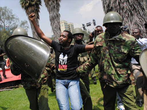 A file photo of Boniface Mwangi being arrested during a protest in 2014. Photo/VIDIJA PATRICK