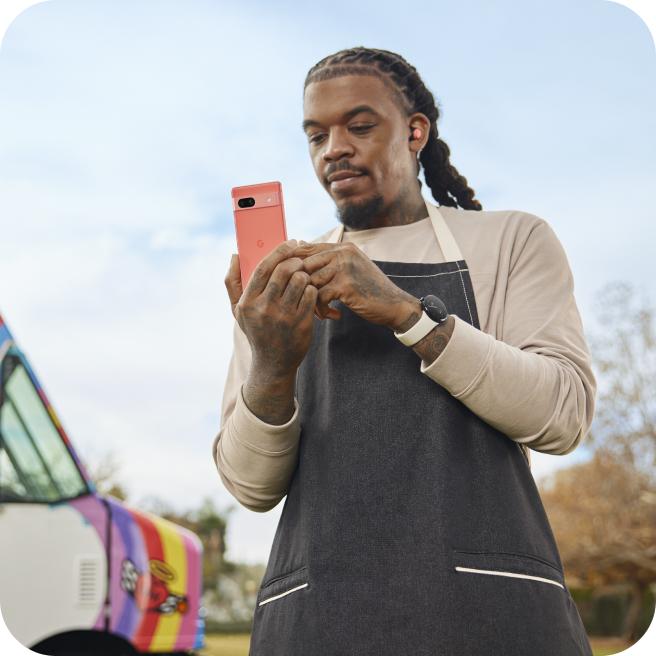 A small business owner working on his Google Pixel 7a phone.