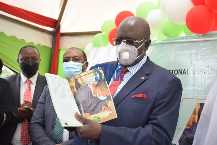 Education CS George Magoha displays the newly-launched KNEC 2021-2026 Strategic plan launch at KNEC Offices in South C on December 22, 2021.