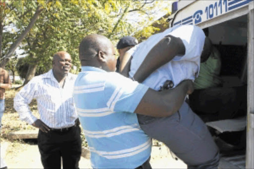 NO FAVOURS: Police officers who allegedly assaulted and demanded money from a suspect allegedly found urinating on the street in March last year are bundled into vans. PHOTOS: MOHAU MOFOKENG