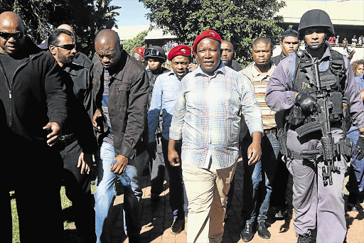 BROTHER IN ARMS: Julius Malema, with bodyguards, at the Durban University of Technology on Friday