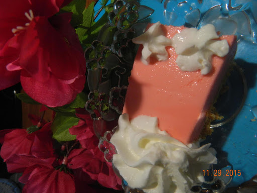 Strawberry Jello Cheesecake with a little whipped cream.