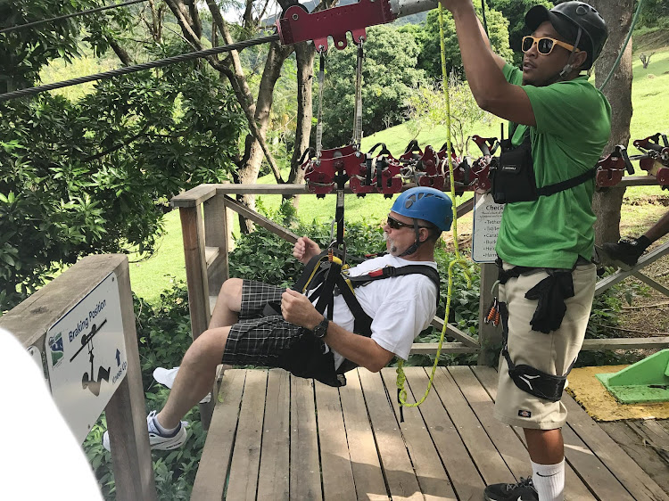 A cruise passenger gets ready to take a zipline ride in St. Kitts.