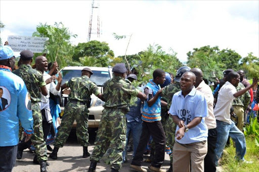 Protesters demonstrate in Blantyre after Malawi police arrested 11 ex-ministers and senior government officials, including the former president's brother, for an alleged coup plot.