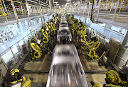 Robots work on the welding line at a Beijing Hyundai Motor Co plant.