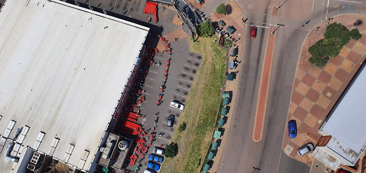 Residents of KwaMashu line up outside a popular retail outlet for groceries.