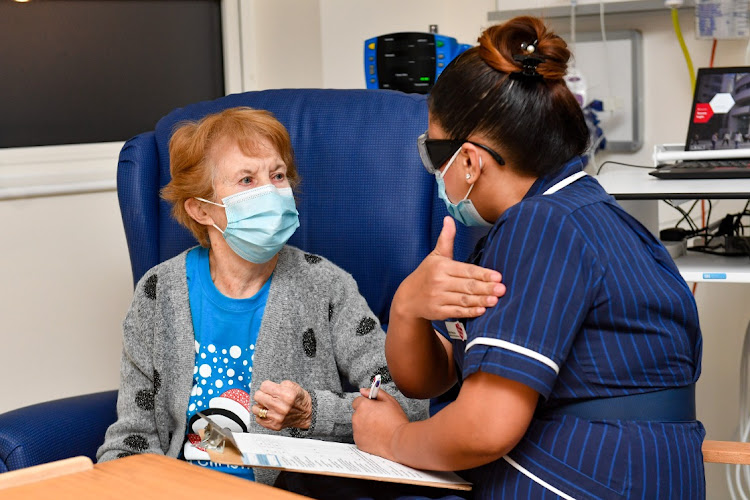 Nurse May Parsons prepares Margaret Keenan, 90, to be the first patient in the United Kingdom to receive the Pfizer/BioNtech covid-19 vaccine at University Hospital, Coventry, at the start of the largest ever immunisation programme in the UK's history on December 8, 2020 in Coventry, United Kingdom.