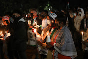 Students and residents take part in a night vigil, 18 May 2021, at the University of Witwatersrand in Johannesburg, for a solidarity picket organised by the Wits Palestine Solidarity Committee, over the occupation and conflict that’s unfolding in Palestine.  