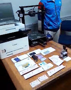 A computer and other equipment believed to have been used in the production of fraudulent documents were seized for further investigation.