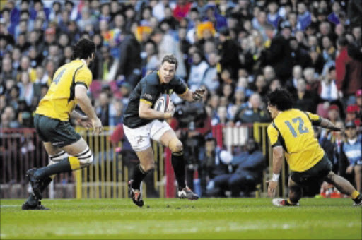 INSPIRED: SA captain Jean de Villiers, centre, in action against Australia on SaturdayPHOTO: GIANLUIGI GUERCIA/AFP