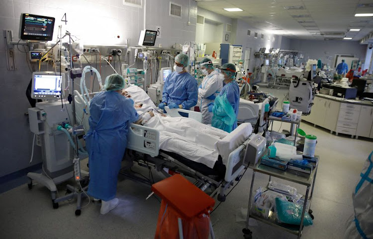 Medical staff members treat patients inside the coronavirus disease (COVID-19) ward at the Central Clinical Hospital of the Ministry of Interior and Administration in Warsaw, Poland, January 11, 2022.