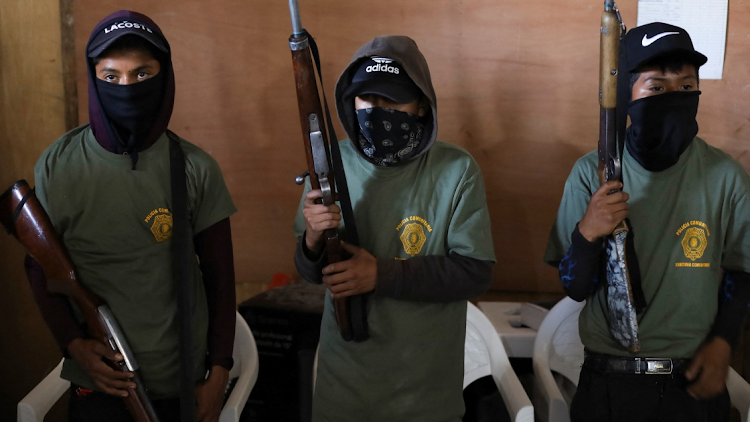 Children hold rifles before a ceremony to join the ranks of the community police, few days after an armed group abducted four people from the community, in Ayahualtempa, Guerrero state, Mexico, January 24, 2024.