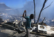 A sign of despair after fire destroys mountainside township Mandela Park in Hout Bay.