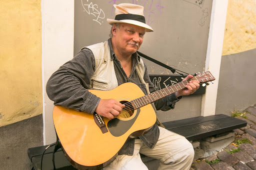 tallinn-street-musician.jpg - A street musician pauses for a visitor in Old Tallinn. 